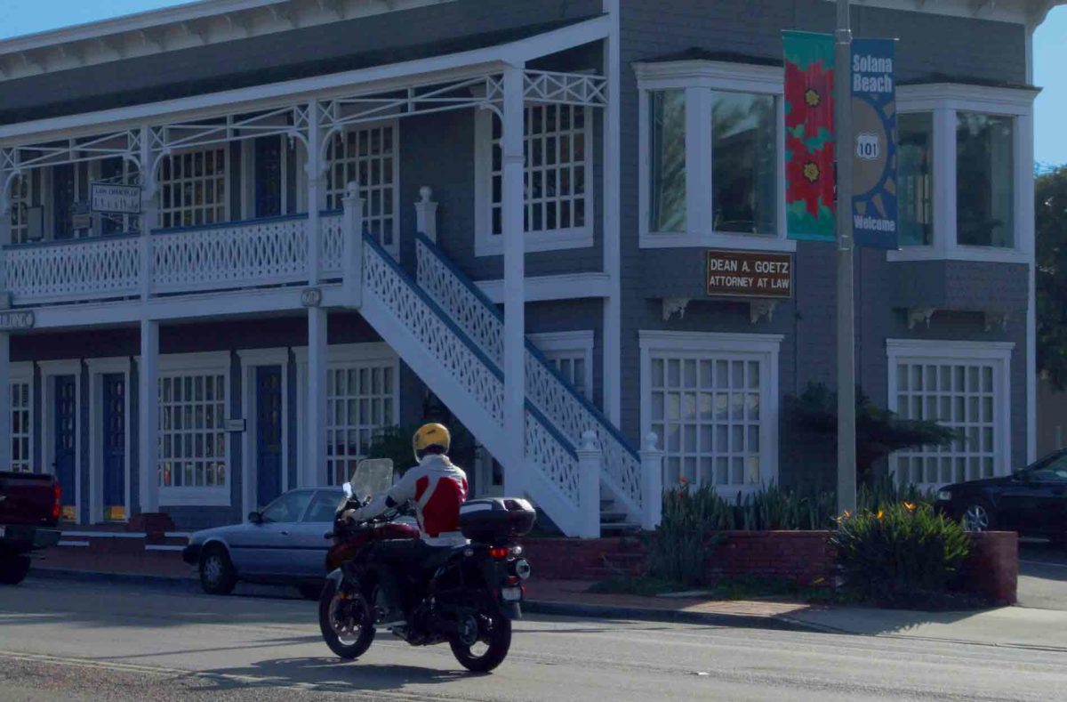 motorcycle rider on hwy 1 in front of Dean Goetz Law Office in Solana Beach